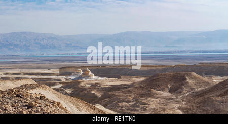 the Dead Sea in Israel and the Moav mountains in Jordan from below Masada showing the landforms and erosion caused by the drying up of the sea Stock Photo