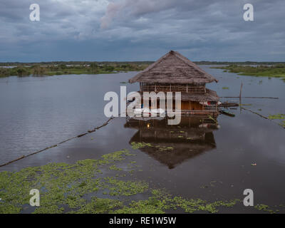 Iquitos, Peru- March 29, 2018: View of a floating house and the Itaya river in the center of Iquitos, Loreto, Peru.  Amazon Stock Photo