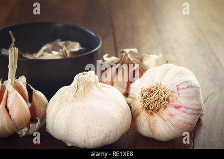 closeup of gardlic bulbs on wood table Stock Photo