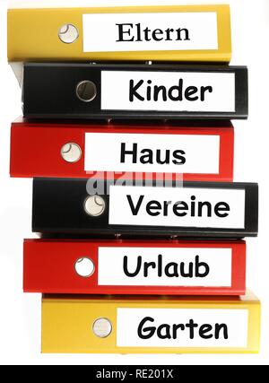 Black, yellow and red ring binders, labelled in German for parents, children, house, clubs, holidays and garden Stock Photo