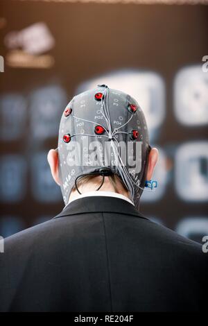 Control of machines and computers through brain activity, electrodes on the scalp detect brain activity and give signals to a Stock Photo