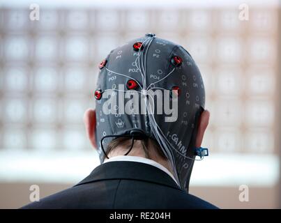 Control of machines and computers through brain activity, electrodes on the scalp detect brain activity and give signals to a Stock Photo