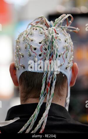 Control of machines and computers through brain activity, electrodes on the scalp detect brain activity and give signals to a Stock Photo