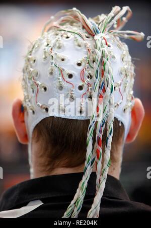 Control of machines and computers through brain activity, electrodes on the scalp detect brain activity and give signals to a Stock Photo