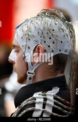 Control of machines and computers through brain activity, electrodes on the scalp detect brain activity and give signals to a Stock Photo