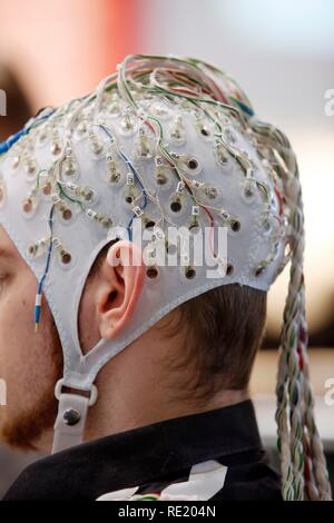 Control of machines and computers through brain activity, electrodes on the scalp detect brain activity and give signals to a Stock Photo