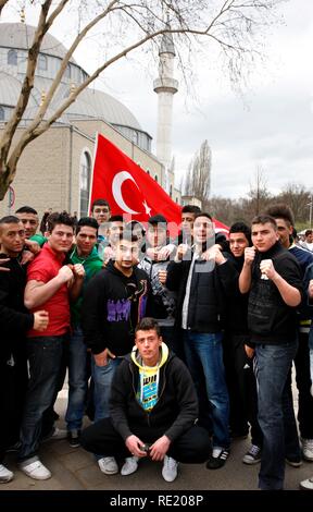Young Turkish men posing in front of the Merkez Mosque during a mass counter demonstration directed against a rally of the NPD Stock Photo