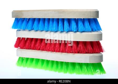 Colourful scrubbing brushes, wooden with plastic bristles Stock Photo