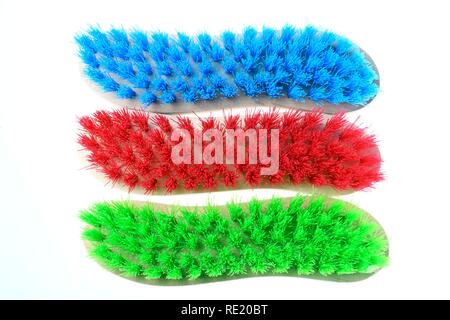Colourful scrubbing brushes, wooden with plastic bristles Stock Photo