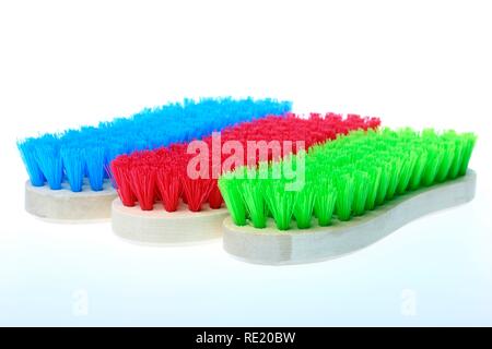 Colourful scrubbing brushes, wooden with plastic bristles Stock Photo