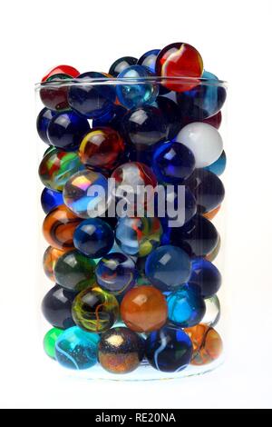 Glass marbles, different colours and sizes, in a glass Stock Photo
