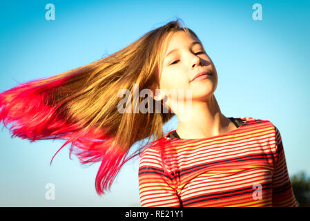 Tween Girl Is Isolated Against The Sky While Twirling And Swinging