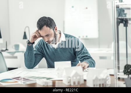 Serious thoughtful man working on his project Stock Photo