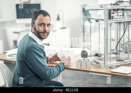 Positive bearded man sitting at the table Stock Photo