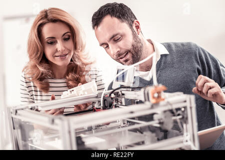 Professional designers watching at white plastic layout Stock Photo