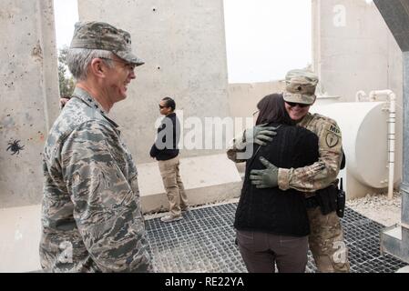 Mrs. Ricki Selva, wife of U.S. Air Force Gen. Paul J. Selva, vice chairman of the Joint Chiefs of Staff, hugs a U.S. Army military policeman, right, at Kandahar Airfield, Afghanistan, Nov. 24, 2016. Gen. Selva and Mrs. Selva visited troops across Afghanistan to spend Thanksgiving Day with them and thank them for their service. Stock Photo