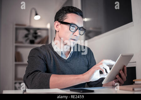 Smart nice IT man using a tablet Stock Photo