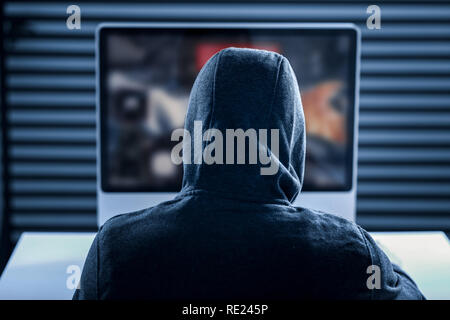 Professional smart gamer looking at the computer screen Stock Photo