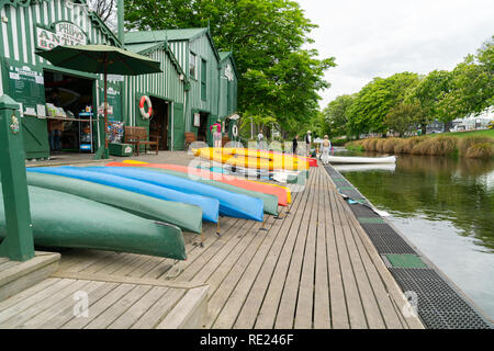 CHRISTCHURCH, NEW ZEALAND - OCTOBER 10 2018; Punting on Avon green and white Antigua Boat Sheds along side of river available for people to hire or be Stock Photo