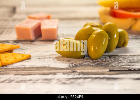 Salty foods on a white and black rustic table. Food for snack. Stock Photo