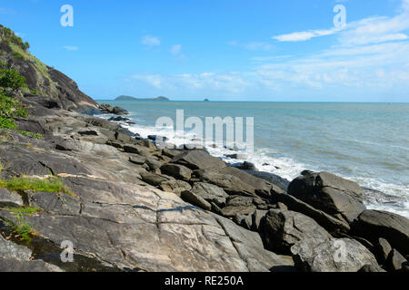 Rocky coastline at Trinity Beach with lapping waves, Cairns Northern Beaches, Coral Sea, Far North Queensland, QLD, FNQ, Australia Stock Photo