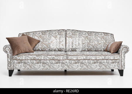 White sofa with vintage style patterns and brown pillows on it isolated at white background Stock Photo