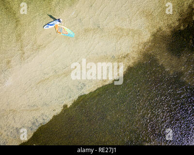 Aerial view of a kitesurfer across shallow clear water in QLD, Australia Stock Photo