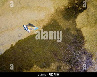 Aerial view of a kitesurfer across shallow clear water in QLD, Australia Stock Photo