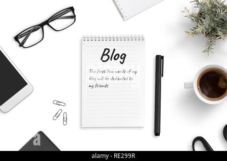 Concept of blogging and freelancing. A few blog words on a pad paper on office desk. Stock Photo