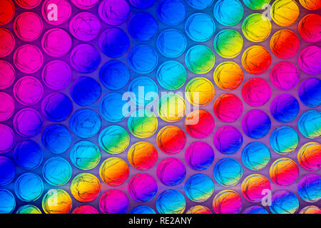 A bright multicolored image taken through a sheet of plastic bubble wrap Stock Photo