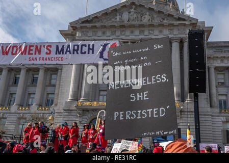 San Francisco, USA. 19th January, 2019. The Women's March San Francisco begins with a rally at Civic Center Plaza in front of City Hall. A sign held high above the crowd bears Mitch McConnell's quote from his attempt to silence Elizabeth Warren: 'She was warned. She was given an explanation - nevertheless, she persisted.' A sign above the crowd  Credit: Shelly Rivoli/Alamy Live News Stock Photo