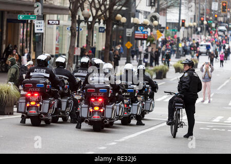 Washington, USA. 19th Jan 2019.  Seattle Police Department leads protestors as into downtown during the Womxn's March Seattle 2019. Saturday’s March and Rally, organized by Seattle Womxn Marching Forward in collaboration with MLK Day organizers, will be followed on Sunday by a day of action and Monday MLK Day events honoring Martin Luther King Jr. Sunday’s Womxn Act on Seattle is a citywide day of learning, supporting, sharing, and acting on behalf of nonprofit organizations, grassroots and social justice groups in Seattle. Stock Photo