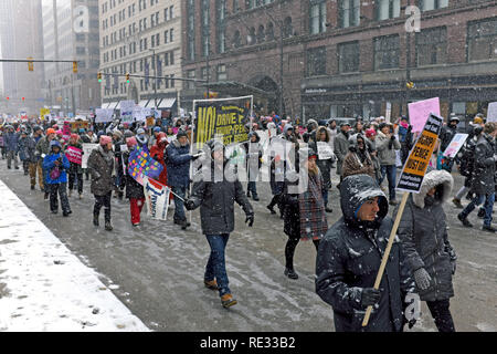 Cleveland, Ohio, USA, 19th January, 2019.  Participants in the 2019 Women's March in downtown Cleveland, Ohio, USA make their way down Superior Avenue during the first major winter storm of the season.  Credit: Mark Kanning/Alamy Live News. Stock Photo