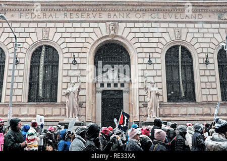 Cleveland, Ohio, USA, 19th January, 2019.  Winter storm Harper, the first major winter storm of the season starts to blanket participants in the 2019 Women's March in downtown Cleveland, Ohio, USA as they pass the Federal Reserve Bank of Cleveland.  Credit: Mark Kanning/Alamy Live News. Stock Photo