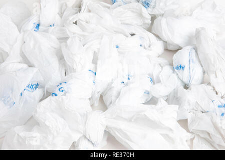 A bunch of crumpled white disposable plastic with blue prints. Stock Photo