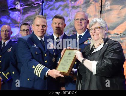 Anne Brengle, president of the Coast Guard Foundation, presents the Coast Guard Foundation Award to Capt. Robert Warren, commander Coast Guard Sector San Juan, Puerto Rico, with Vice Adm. Karl Schultz, commander Coast Guard Atlantic Area, and Rear Adm. Scott Buschman, commander 7th Coast Guard District, at the 23rd Annual Coast Guard Foundation 7th Coast Guard District Tribute Dinner Wednesday, Nov. 16, 2016. Sector San Juan members were recognized and honored for their actions during the Caribbean Fantast Ferry Fire Response near Puerto Rico in August where they resuced more than 500 people f Stock Photo