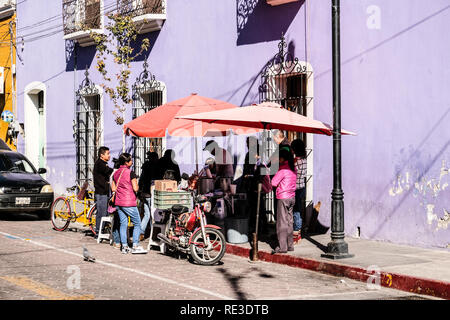 Mexican locals gather around a street food vendor in the morning at Puebla, Mexico Stock Photo