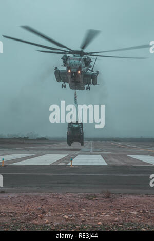 A U.S. Marine Corps CH-53E Super Stallion lifts a 7-ton truck while conducting a Helicopter Support Team training exercise at Marine Corps Air Station Miramar, California, Jan. 17, 2019. The training was executed to show vehicle transportation. (U.S. Marine Corps photo by Lance Cpl. Betzabeth Y. Galvan) Stock Photo