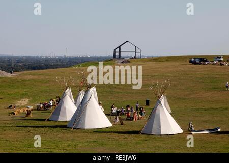 Indian tents and art object Hallenhaus on the Halde Norddeutschland mining waste tip near Neukirchen-Vluyn Stock Photo