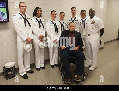 (COLLEGE STATION, Texas) Former President George H.W. Bush poses for a portrait with Sailors assigned to USS George H.W. Bush (CVN 77) during a military appreciation football game at Texas A&M University. The game is part of a two-day namesake trip to Texas where Sailors engaged with the local community about the importance of the Navy in defense and prosperity. Stock Photo