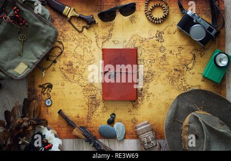 Old map, vintage travel equipment and souvenirs from the travel around the world Stock Photo