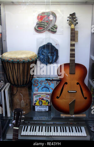 Old vintage second hand instruments displayed on a glass cabinet vintage shop en Brighton, England, UK Stock Photo