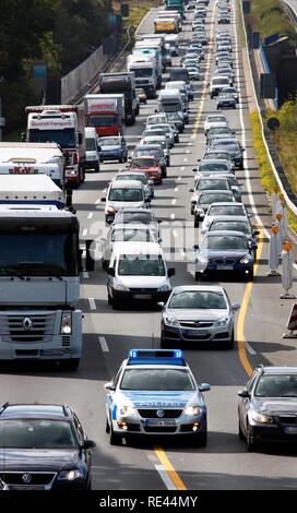 Police patrol car of the highway patrol weaving through a traffic jam to get to a car accident on the A2 highway Stock Photo