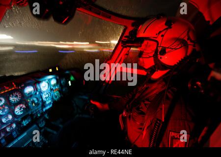 Patrol helicopter with night flying capability, image intensifier, infrared camera, pilot with night vision gear, night mission Stock Photo