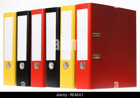 Black, yellow and red ring binders, blank labels Stock Photo