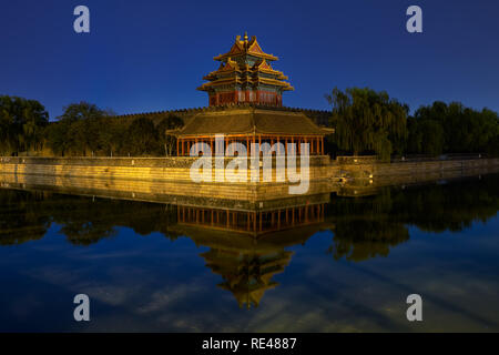 Beijing / China - October 10th 2018: Northwestern tower of the Forbidden City reflecting in the water moat during still night.