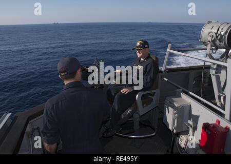 MEDITERRANEAN SEA - (Nov. 26, 2016) - Cmdr. Peter Halvorsen, commanding officer, USS Carney (DDG 64), right, and Lt. j.g. Xavier Jimenez, conning officer, conduct tactical maneuvering exercises with the Spanish Navy replenishment ship ESPS Cantabria (AOR 15) and the Royal Canadian Navy frigate HMCS Charlottetown (FFH 339) during exercise Mavi Balina 16 in the Mediterranean Sea Nov. 26, 2016. Carney, an Arleigh Burke-class guided-missile destroyer, forward-deployed to Rota, Spain, is conducting a routine patrol in the U.S. 6th fleet area of operations in support of U.S. national security intere Stock Photo