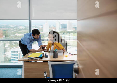 Business People Laughing In Office Watching Video Pictures On Smartphone Stock Photo
