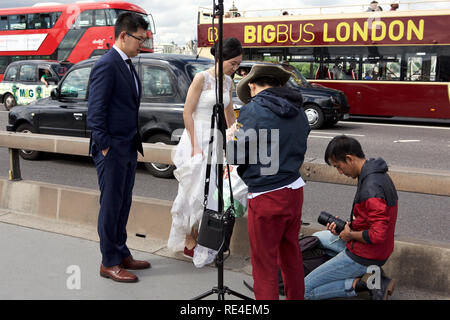 A Chinese pre-wedding photo shoot on Westminster Bridge in London. Stock Photo