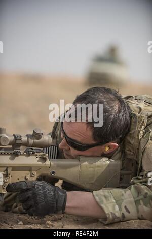 Tech. Sgt. Jeremy Rarang, 817th Expeditionary Air Support Operations Squadron joint terminal attack controller, fires an M110 Semi-Automatic Sniper System during training at Forward Operating Base Dahlke, Afghanistan Nov. 21, 2016. JTACs are often assigned to sister service units to bridge the gap between air and ground assault operations. Stock Photo